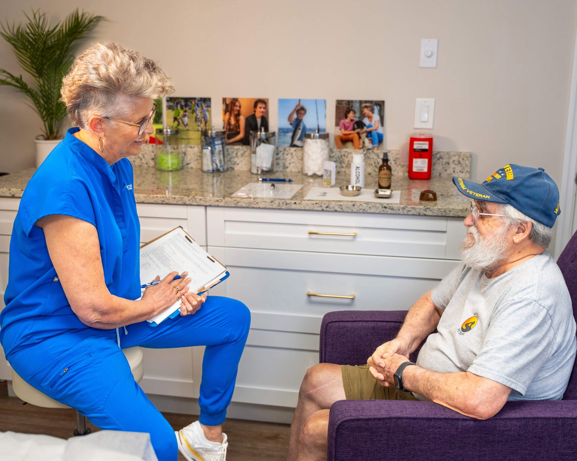 Dr. Kim Windschauer, AP with a veteran patient — CARE study, Clearwater FL Dr. Kim Windschauer, AP, reviewing acupuncture treatment options with a U.S. military veteran during the Department of Defense–funded CARE study at Acupuncture of West Florida in Clearwater, FL.